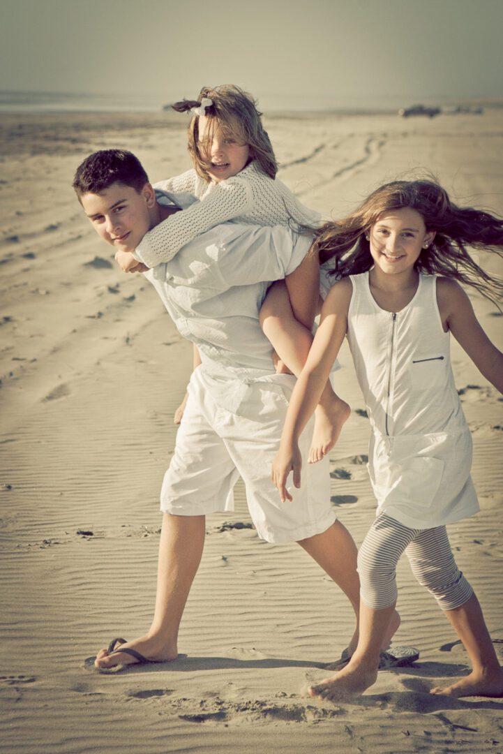 A family of three playing on the beach