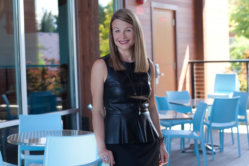 A woman wearing a black dress standing in a restaurant