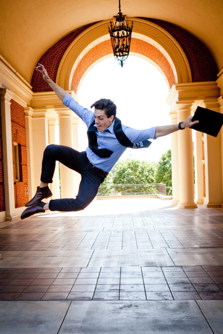 A man jumping in the air with his arms outstretched.